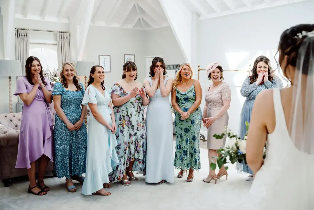 mixed floral bridesmaids dresses as bridesmaids react to seeing brides dress for first time