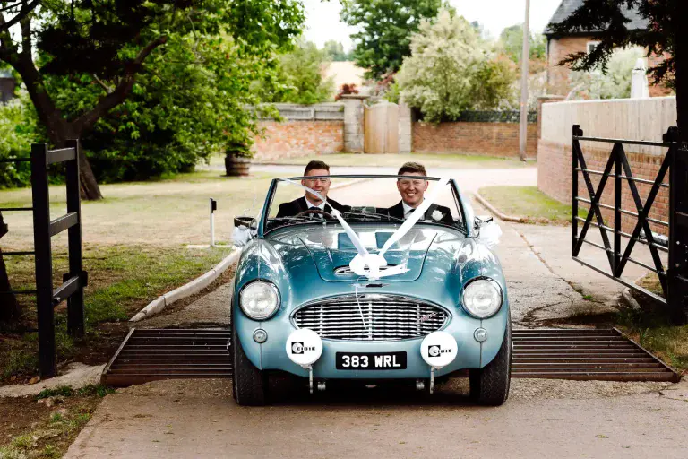 two men in a convertible car