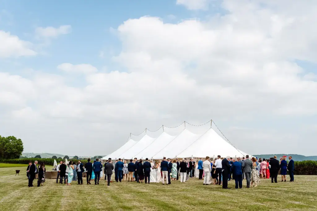 a marquee surrounded by wedding guests at a somerset wedding