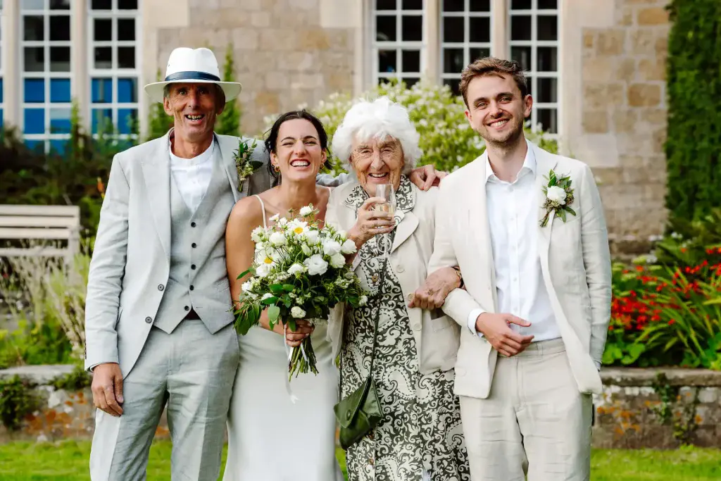 bride and groom pose with their two other family members for their wedding photography