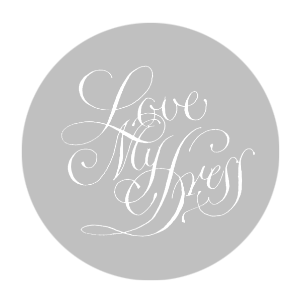 a grey circle with white text saying love my dress